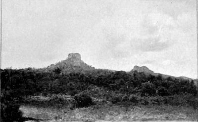Isolated Conical Hills with Tower-like Rocky Formation on Summit.