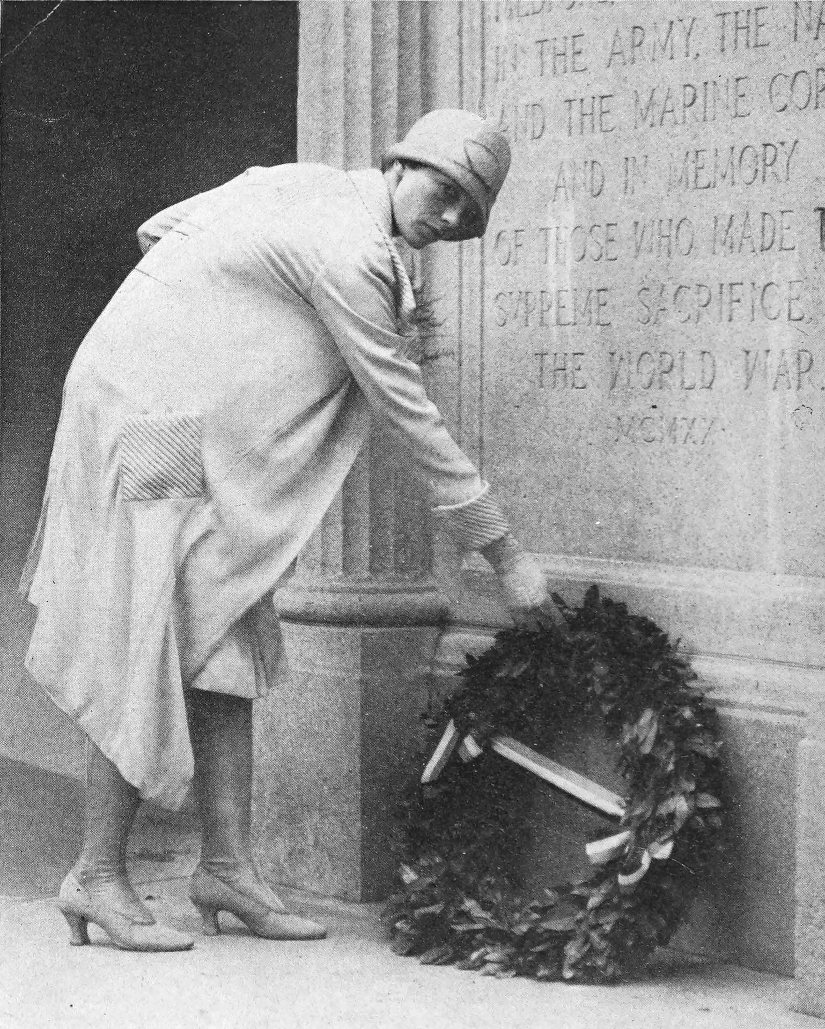 Photo full shot Earhart laying wreath at the base of
                the Medford, Massachusetts Honor Roll Memorial